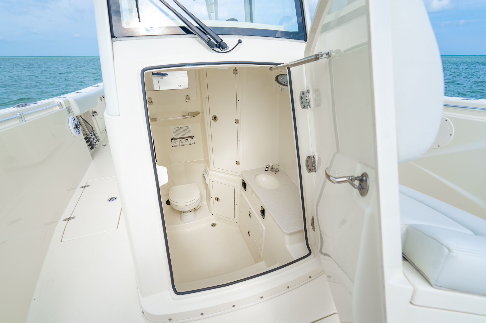 A front-opening console door and staired entry make accessing the spacious head easy for everyone on board. Inside, you'll find plenty of room to move comfortably along with a sink and thoughtful amenities that make longer days on the water more enjoyable. 