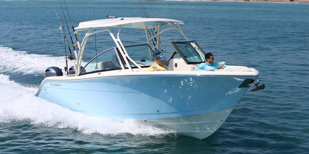 Close front angle view of Cobia 280 Dual Console running with people sitting at bow.